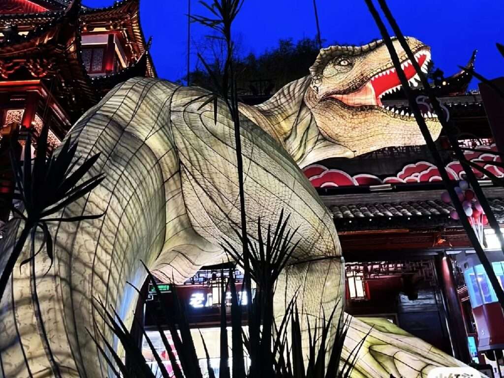 Install giant dinosaur lanterns