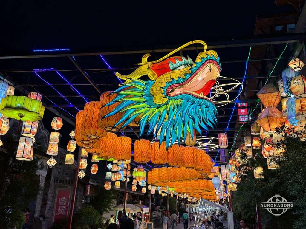 Glowing Custom Chinese Dragon Lantern with green and yellow details at an outdoor festival night display