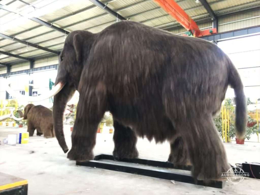 life-size animatronic prehistoric mammoth with realistic fur and tusks