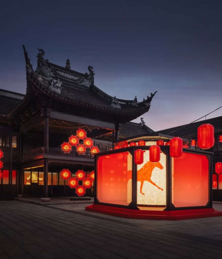 Audience interaction within lantern-lit exhibition space