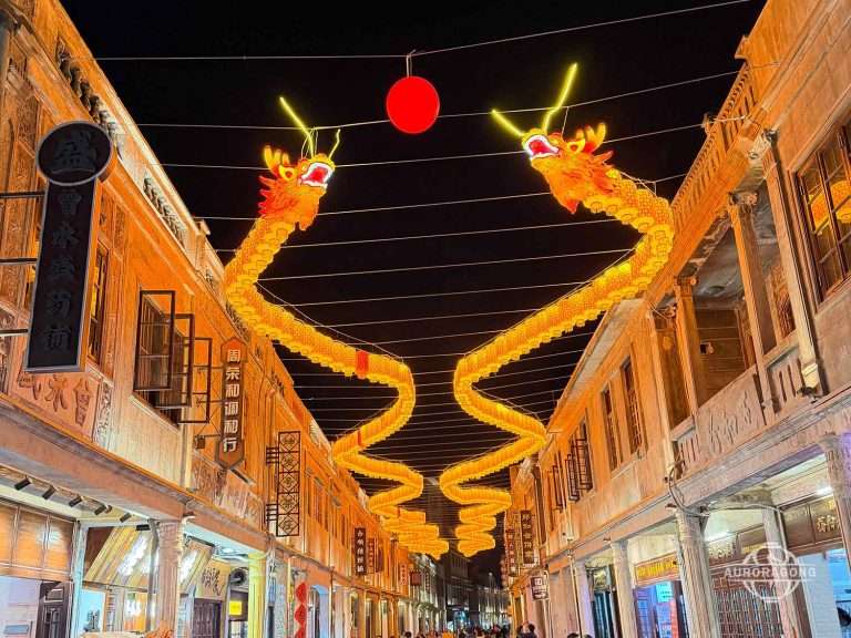 Large Chinese New Year lanterns at shopping mall entrance attracting visitors