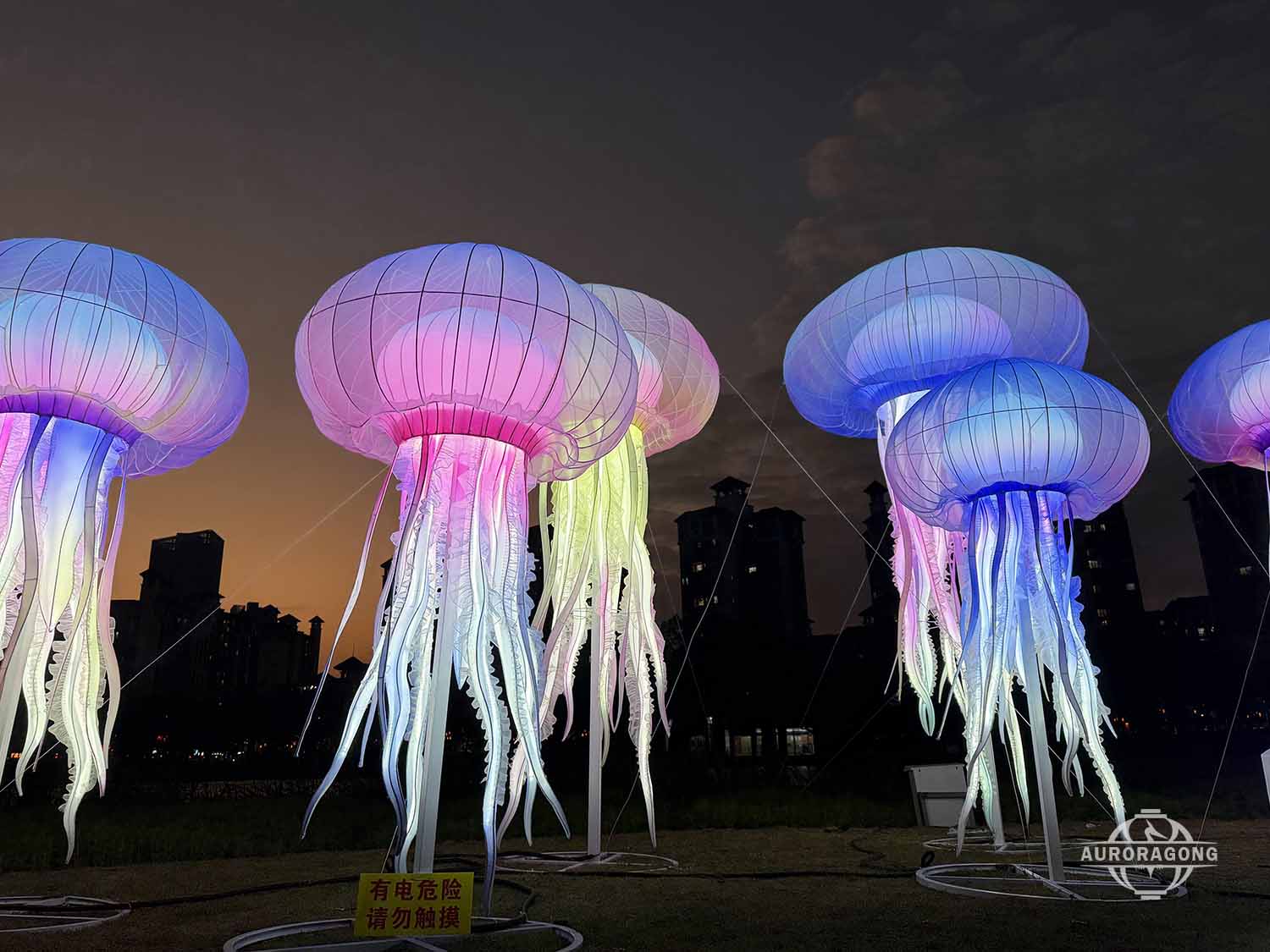 Floating jellyfish lantern cluster night view commercial lighting installation