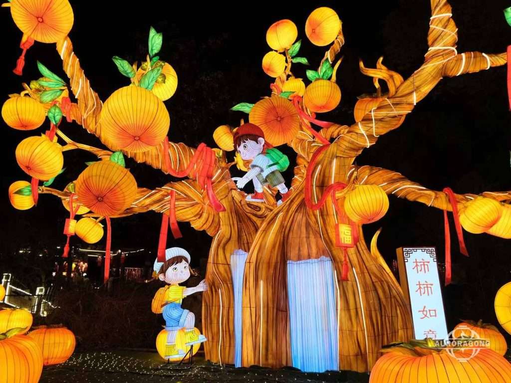 Illuminated persimmon tree lantern with glowing orange fruits and a boy character climbing the tree