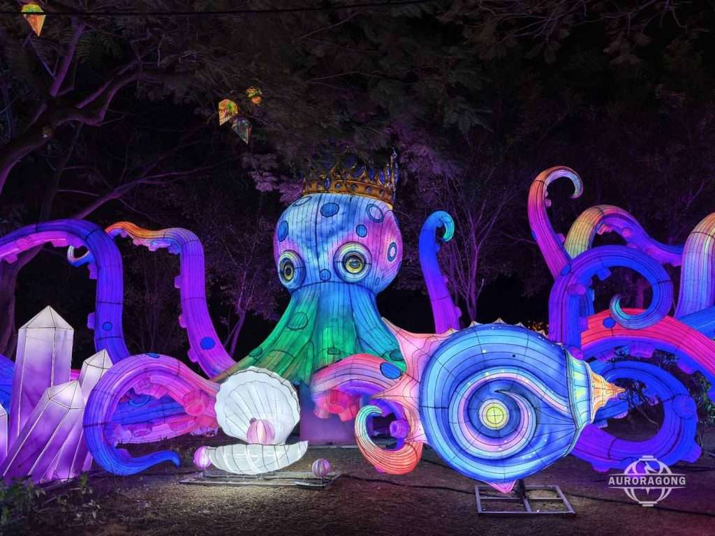 Custom illuminated deep sea themed lantern with crown octopus, crystal, and shell decorations at night