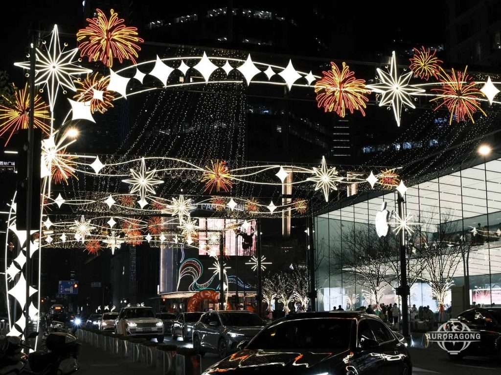 Custom large LED passage light arch with golden fireworks and star decorations across a city street at night