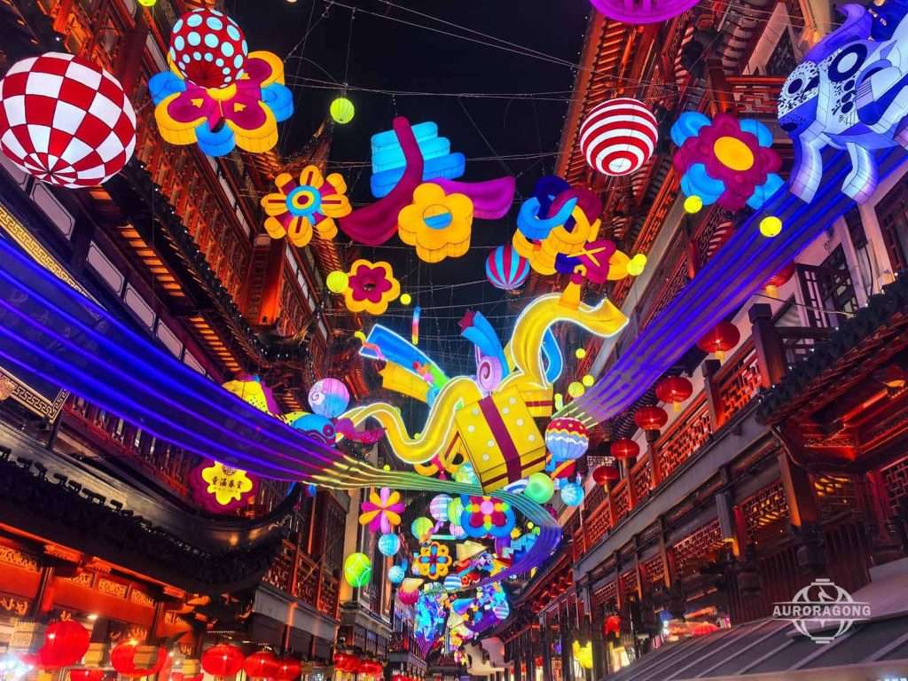 Chinese New Year hanging lantern display in an indoor mall atrium with dragon and flowers