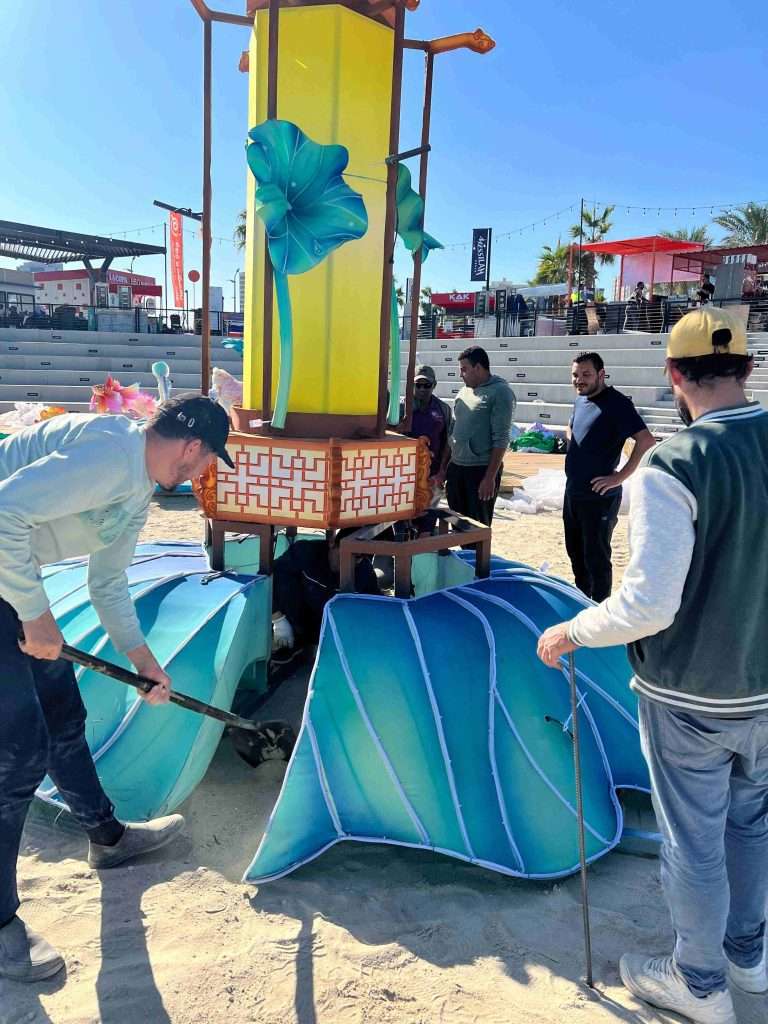 Engineering team and local workers assembling light festival structures at Fiesta City