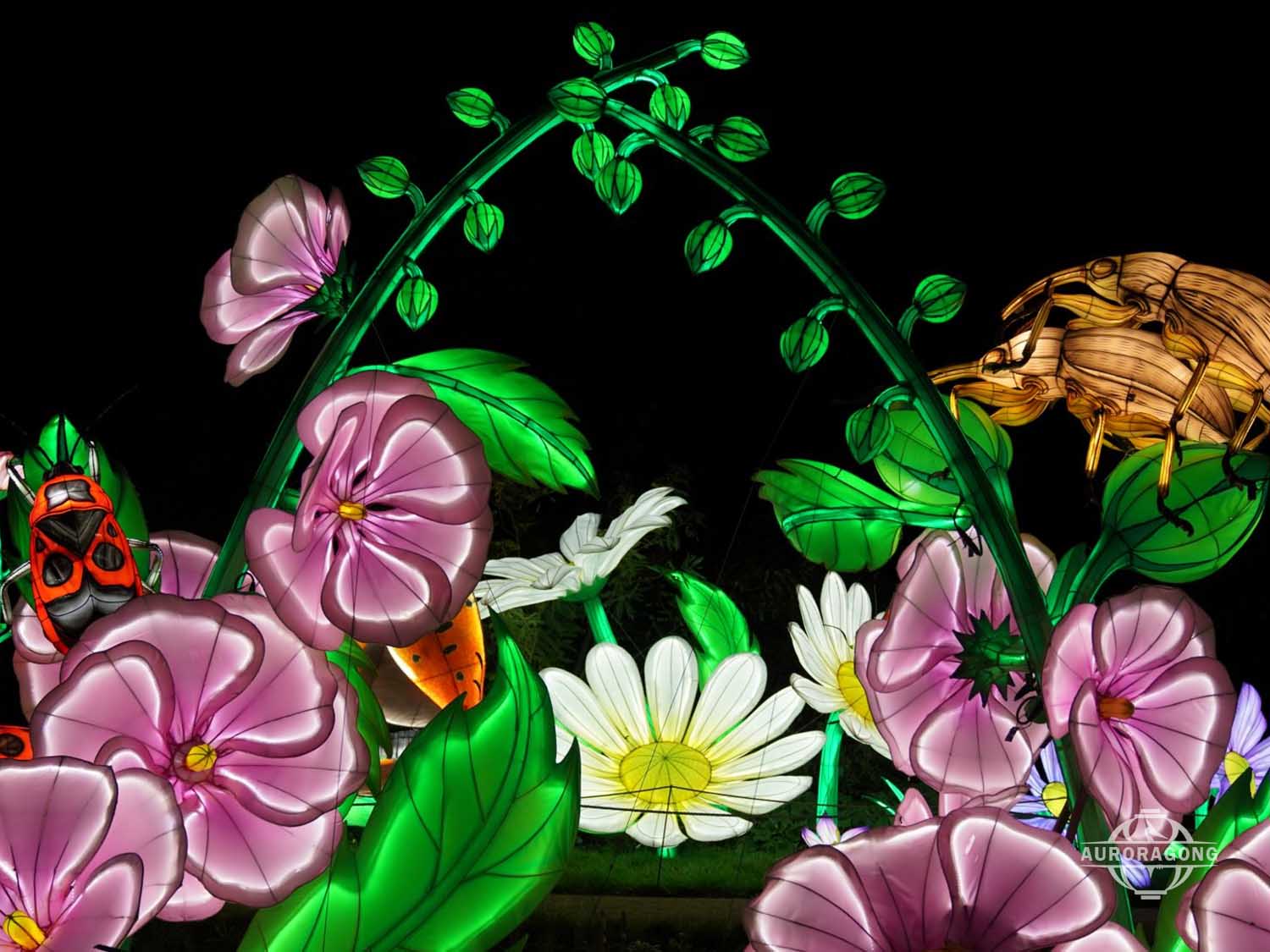 Custom illuminated insect and flower lantern with pink morning glories, yellow daisies, and insects at fantasy garden event