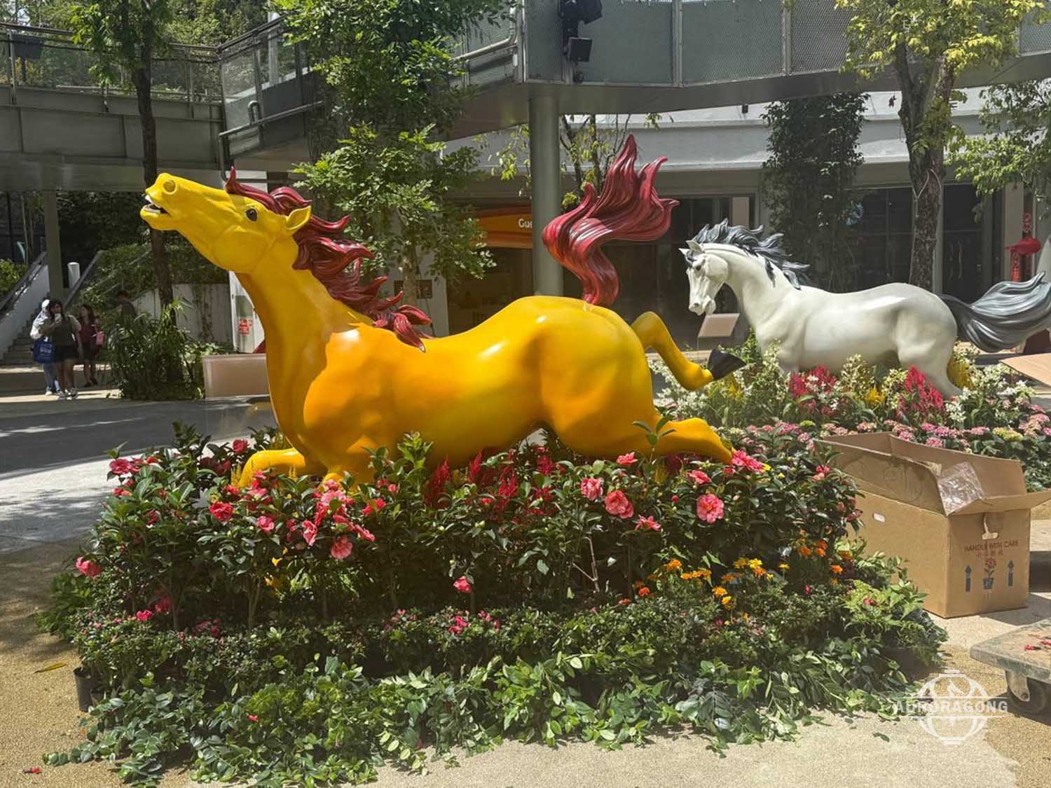 Colorful fiberglass horse sculpture with yellow running horse design