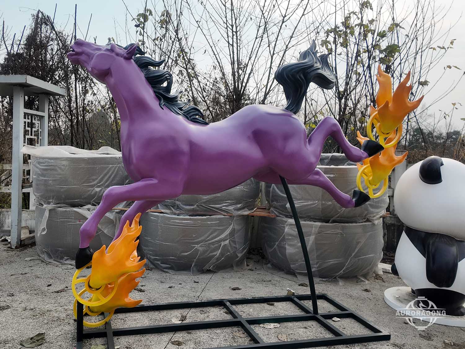 Colorful fiberglass horse sculpture with purple running horse design