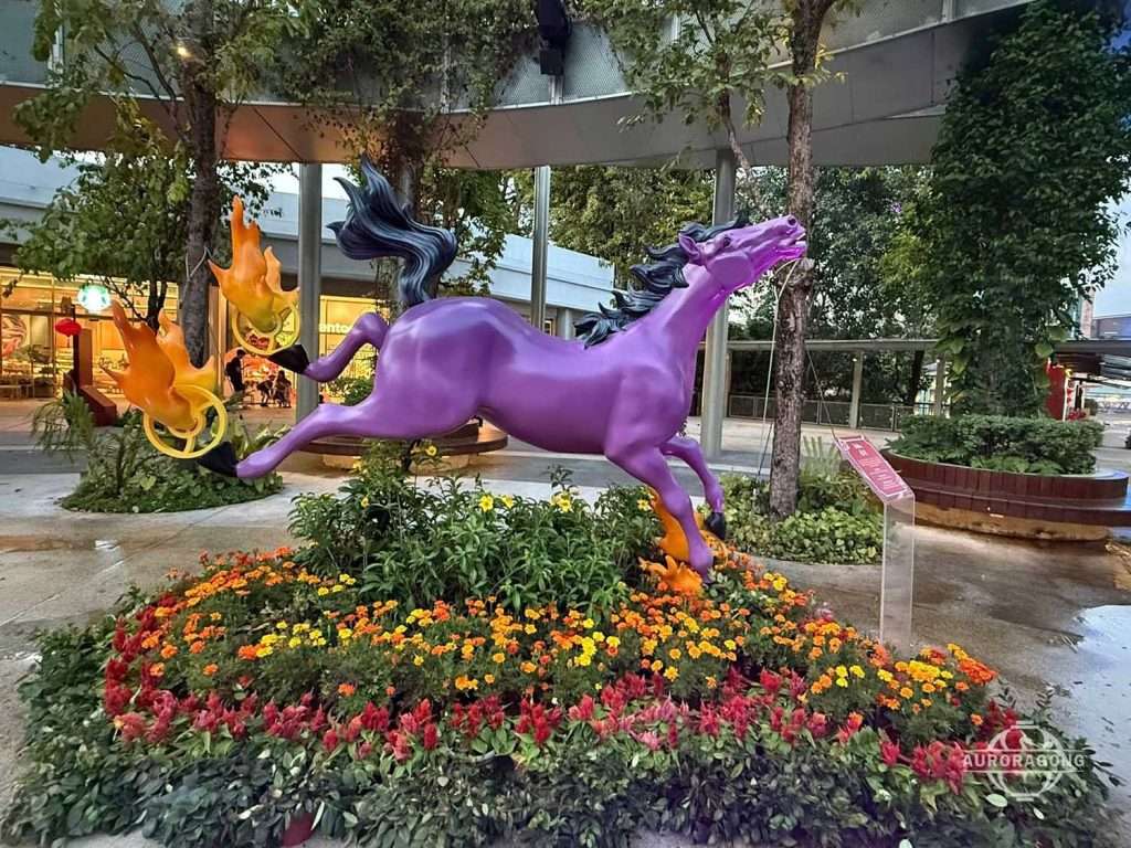 Purple fiberglass horse sculpture installation
