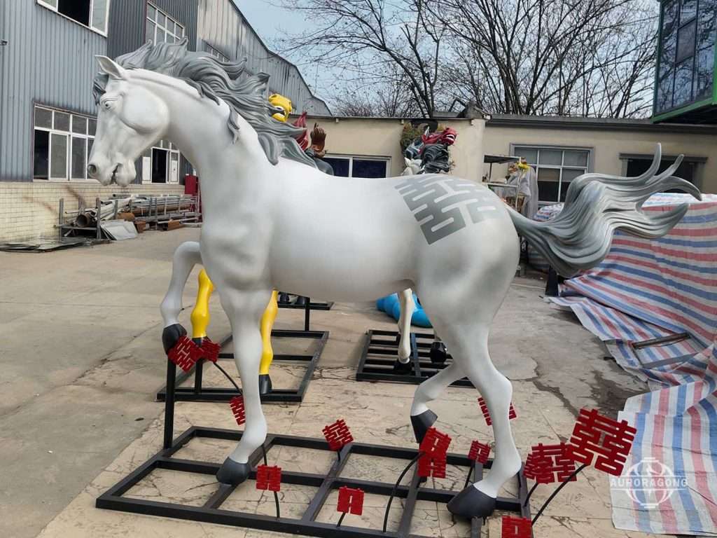 White fiberglass horse sculptures prepared for shipment at AuroraGong factory yard