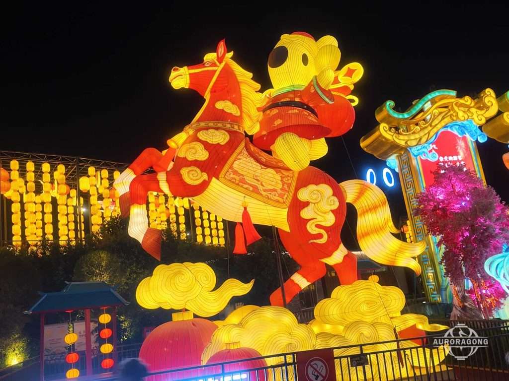 Large illuminated Chinese-style horse lantern in orange and red with golden cloud motifs