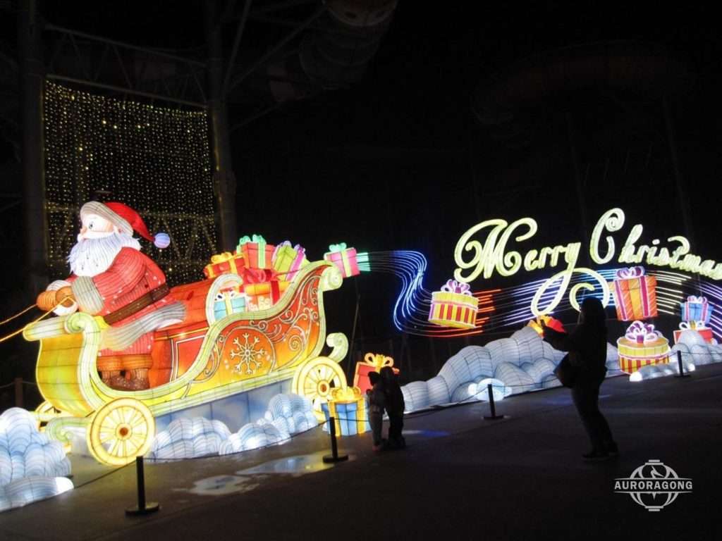 Christmas Santa sleigh and reindeer glowing lantern group with gifts and Merry Christmas sign