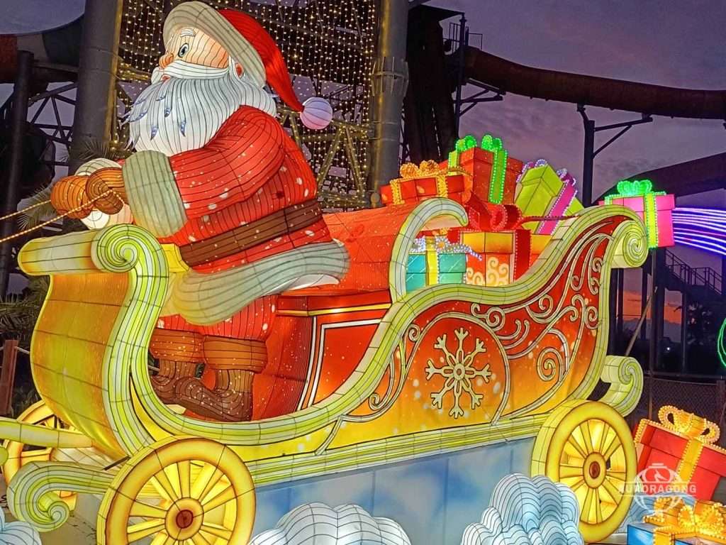Santa Claus sitting in glowing Christmas sleigh with colorful gifts for holiday festival