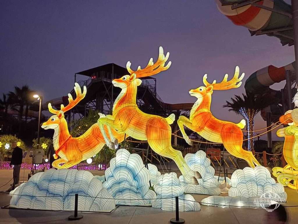 Glowing flying reindeer pulling Christmas sleigh through clouds for holiday festival