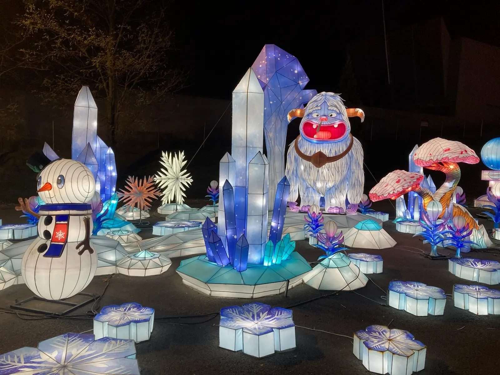 Large-scale illuminated festival display in a city plaza at night