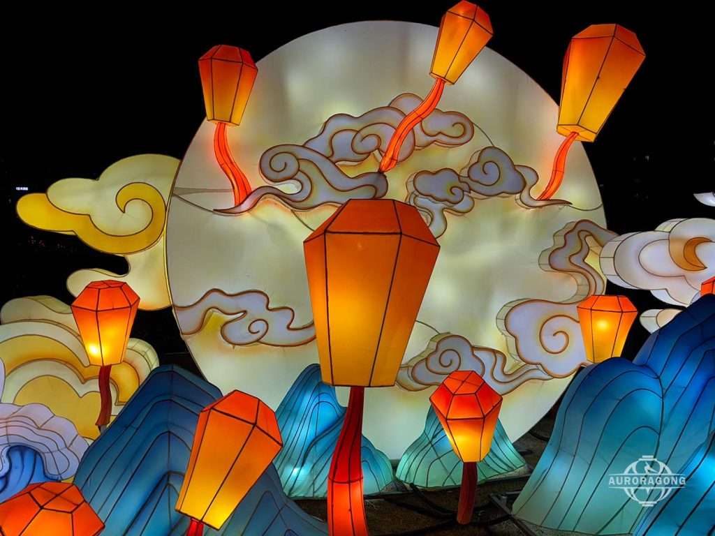 Custom lantern solution for Mid-Autumn festival with red and orange flying wish lanterns in front of a moon and clouds
